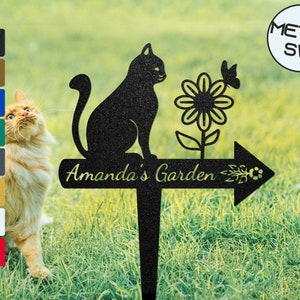 Garden directional sign stake with black cat silhouette, flower, and right arrow