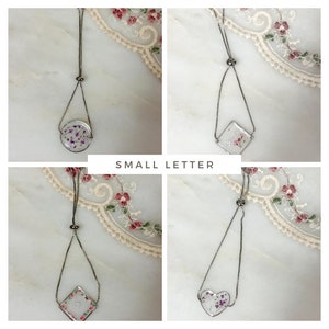 Adjustable silver-tone monogram bracelet with dried-flower round charm and chain