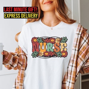White nurse-themed floral graphic T-shirt with colorful 'NURSE' lettering