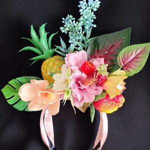 Floral tropical headband with pink roses, pineapple-style fruit, and green leaves