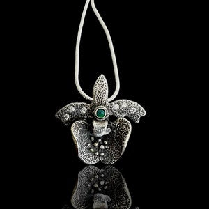 Silver orchid pendant with green opal center, leaf-shaped petals, teardrop bail