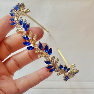 Gold-tone headband with blue rhinestone marquise and gold crystal accents