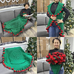 Green crochet shawl with red pom accents, draped over shoulders on model
