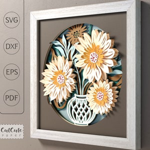 Layered paper flower shadow box design with white daisies, teal leaves, and vase