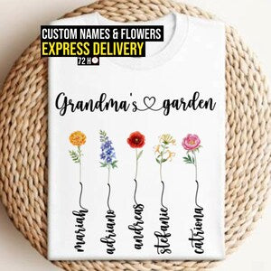 White graphic T-shirt with colorful flowers and handwritten-style grandma names text
