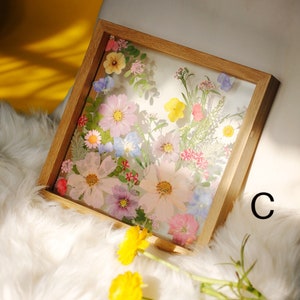 Wooden dried flower frame with pressed pastel floral collage, easel display