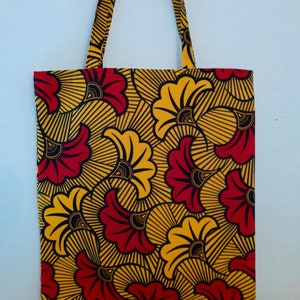 African wax print tote bag in red, yellow, and black with short handles