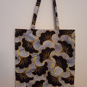 Floral print tote bag in black and gold with fabric handles