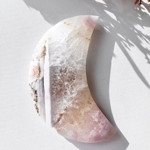Pink flower agate moon carving with dendritic white details and curved cutout