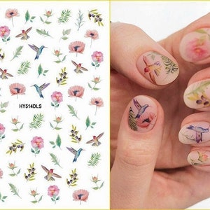 Self-adhesive nail stickers sheet with colorful birds and flowers; shown on fingernails