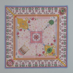Square multicolor tapestry with decorative border and central geometric emblem