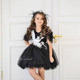 Black tulle tutu dress with white feather wing applique and short puff sleeves