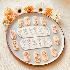 Floral polymer clay stamp set with multiple small flower and leaf designs on stamps