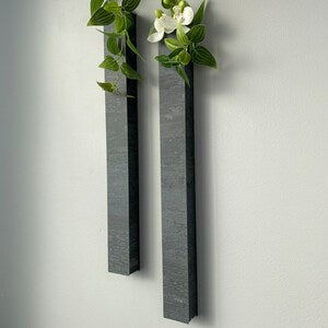 Pair of tall wall-mounted single flower vases in dark gray rectangular holders