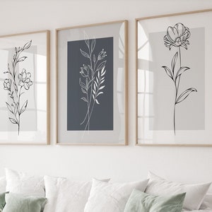 Set of 3 botanical line art prints in white frames, monochrome flower and leaf designs