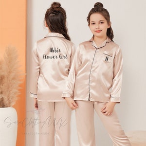 Kids satin pajama set, light beige, button-up top with embroidered name detail and pants