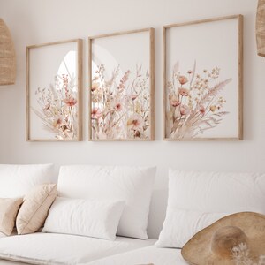 Set of 3 botanical wall art prints in light wood frames with pink-beige wildflowers