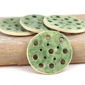 Green ceramic flower frog disc with multiple round holes for flower arranging