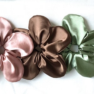 Satin flower scrunchies: pink, bronze, and sage-green oversized hair ties