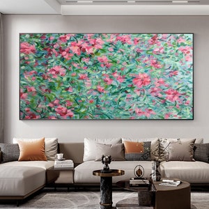 Large framed canvas oil painting with abstract pink blossoms and green foliage landscape.