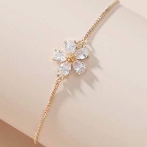 Gold-tone dainty rhinestone flower bracelet with small chain and bright floral charm