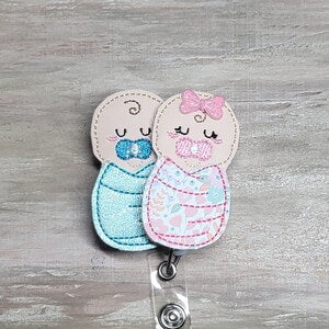 Shimmery flower burrito baby swaddle blanket clip with two stitched baby designs