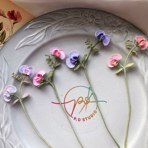 Handmade crochet flower bookmark with pink and purple blossoms and thin stems