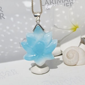 Carved blue lotus gemstone pendant on silver chain