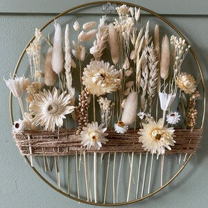 Boho wall hoop decor with metal ring, jute cord, dried beige flowers, and feathers