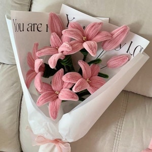 Handcrafted pink flower bouquet with ribbon wrap