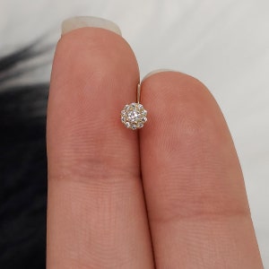 Dainty flower-style nose stud with round CZ stones on gold-tone post