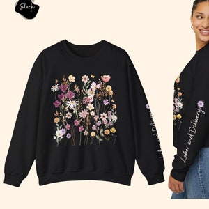 Black crewneck sweatshirt with colorful wildflower bouquet graphic on front