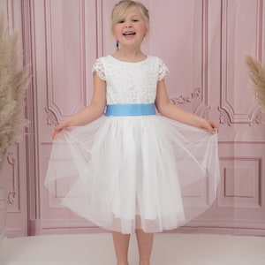 White lace bodice tulle flower girl dress with blue sash, knee-length skirt