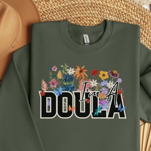 Dark green crewneck sweatshirt with Doula floral front graphic