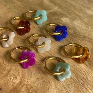 Gold-tone hoop earrings with multicolor flower charms, stainless steel look