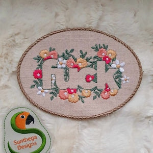 Embroidered floral flower sign patch in an oval hoop with decorative border
