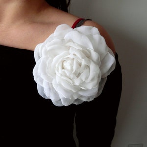 Large white silk rose flower brooch with layered petals on pin-back base