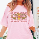 Pink graphic T-shirt with floral print and slogan text across the chest