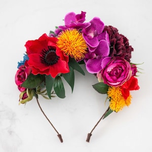 Floral headband with red, pink, purple, orange flowers and green leaves
