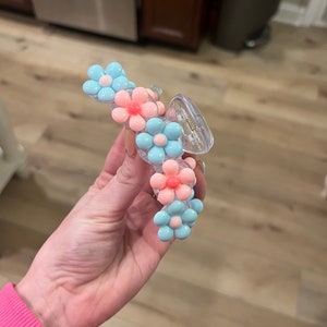 Pastel blue and pink flower claw clip with a clear plastic center