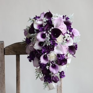 Purple and white cascading bridal bouquet with calla lilies, roses, and small blooms