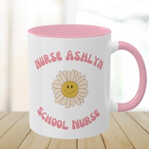 Nurse mug, white with pink rim and handle; 'NURSE ASHLYN' with sunflower graphic