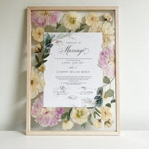 Framed pressed flower keepsake artwork with floral border and white certificate