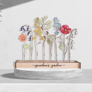 Wooden Grandma's garden keepsake with cutout flower stems and multicolor blooms on base