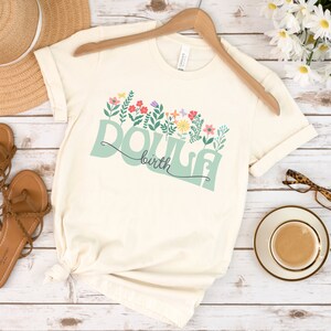 Cream short-sleeve T-shirt with floral birth graphic
