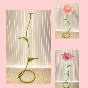 Giant free-standing paper flower stem with pink bloom, green leaves, coiled base
