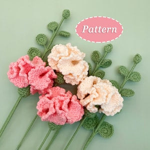 Crochet flower bouquet with carnation-style blossoms and eucalyptus leaf accents