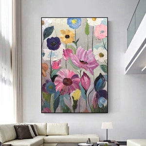 Framed abstract flower canvas wall art with colorful pink, purple, and yellow blooms