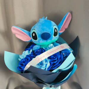 Blue Stitch-style plush bouquet with pink ears and blue ribbon wrap