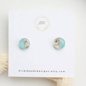 Turquoise pressed-flower stud earrings with tiny multicolor petals, plastic posts